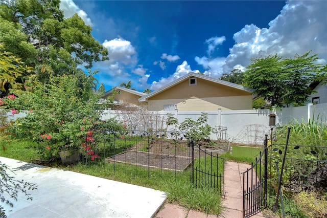 exterior space with a vegetable garden and fence