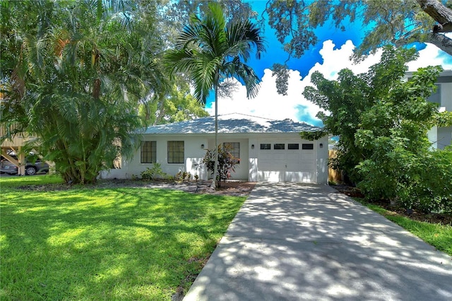 ranch-style home with concrete driveway, an attached garage, a front lawn, and stucco siding