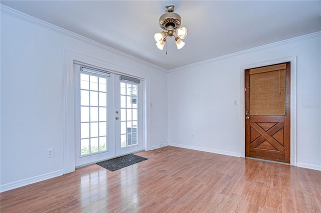 entryway featuring light wood-style floors, a wealth of natural light, french doors, and crown molding