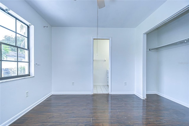 unfurnished bedroom with a ceiling fan, a closet, baseboards, and wood finished floors