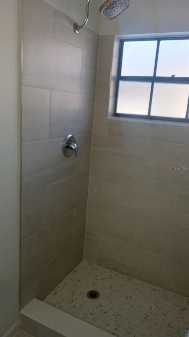 bathroom with a tile shower