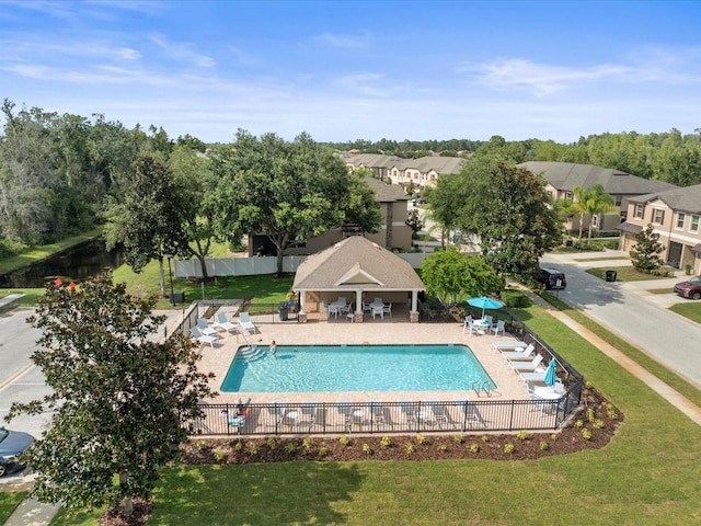 view of pool with a lawn