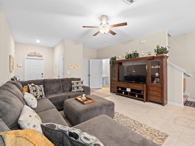 living room with ceiling fan and light tile patterned flooring