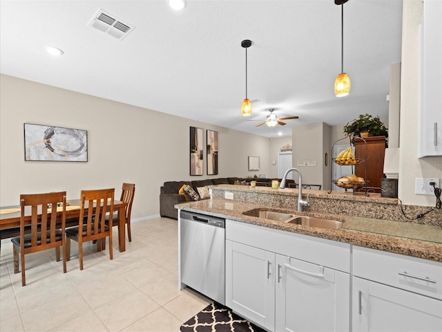 kitchen featuring ceiling fan, stainless steel dishwasher, white cabinetry, light tile patterned floors, and sink