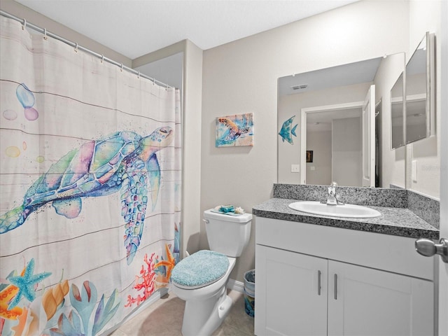 bathroom with tile patterned floors, toilet, and vanity