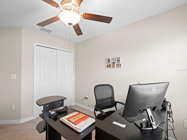 office space with ceiling fan and light colored carpet