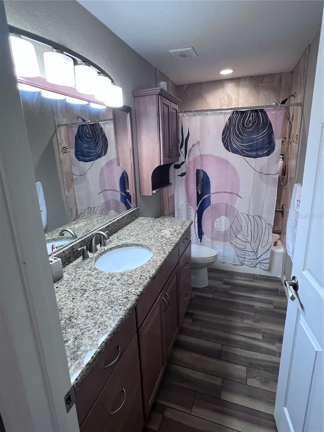 full bathroom featuring shower / bath combination with curtain, toilet, and vanity