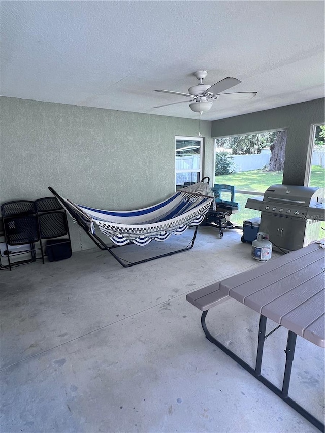 view of patio featuring ceiling fan and a grill