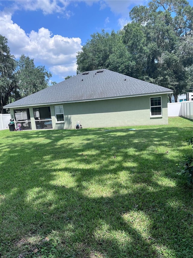 back of property featuring a lawn