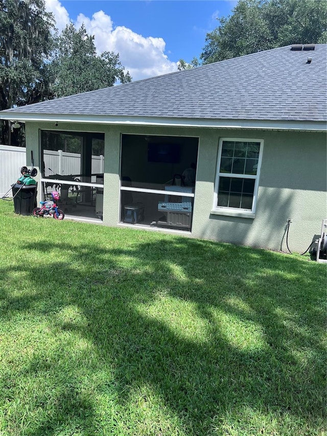 back of house with a yard