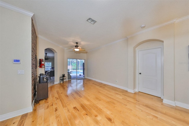 living room with a textured ceiling, crown molding, ceiling fan, and light hardwood / wood-style floors