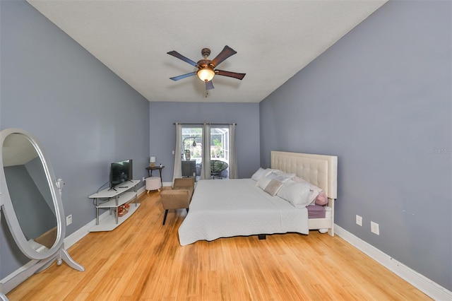 bedroom with ceiling fan, wood finished floors, and baseboards