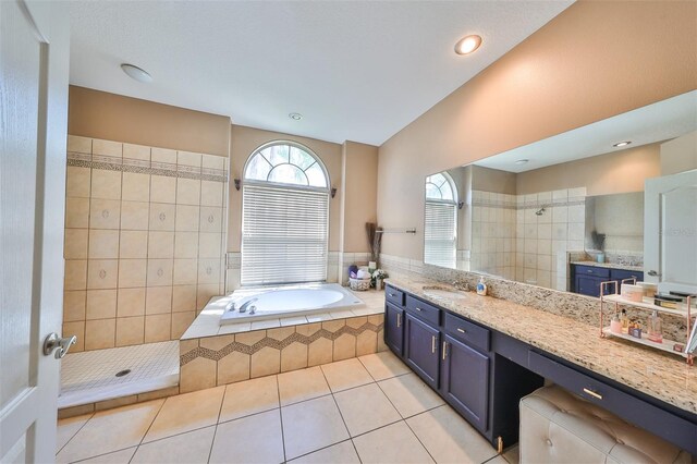 bathroom featuring vanity, tile walls, independent shower and bath, and tile patterned floors