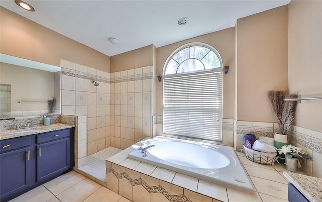 bathroom featuring tile patterned floors, separate shower and tub, and vanity