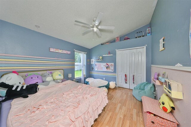 bedroom featuring lofted ceiling, a closet, ceiling fan, and light hardwood / wood-style floors