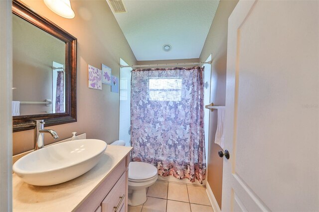 full bathroom with vanity, toilet, shower / bath combination with curtain, and tile patterned flooring