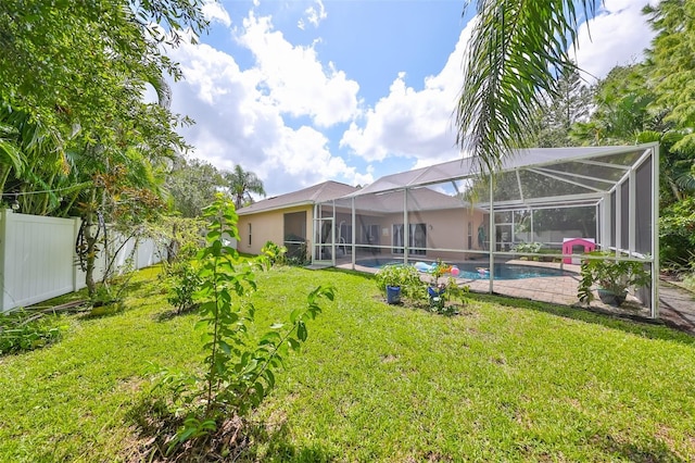 view of yard with glass enclosure, a fenced backyard, and an outdoor pool