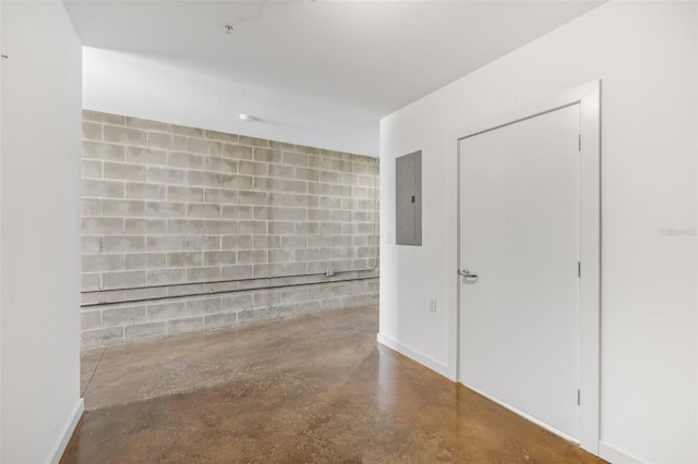 spare room with concrete flooring and electric panel