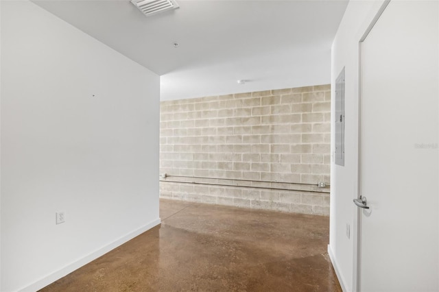 bathroom featuring finished concrete flooring, baseboards, visible vents, and concrete block wall