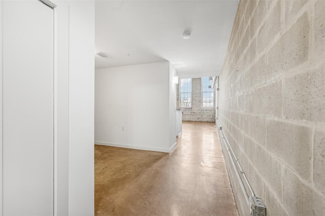 hallway with concrete floors