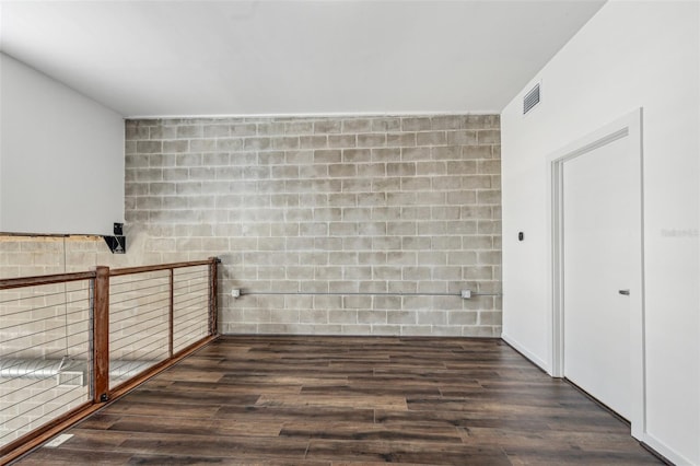 unfurnished room featuring dark wood-type flooring