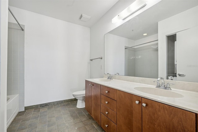 bathroom featuring baseboards, a sink, toilet, and double vanity