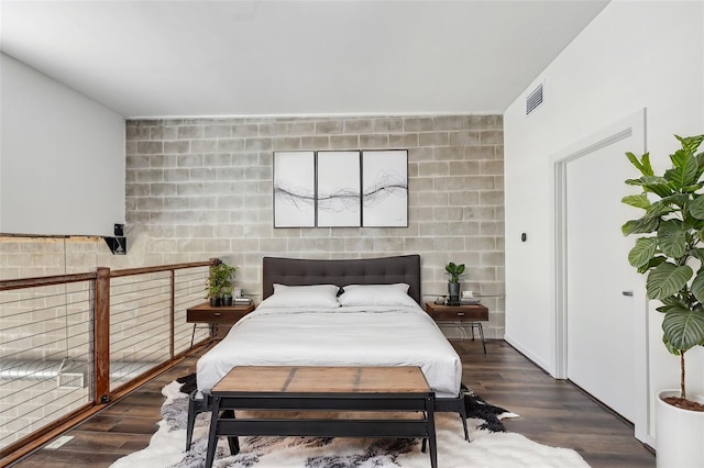 bedroom with dark wood-style floors and visible vents