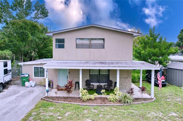 view of front of house featuring a front lawn and covered porch