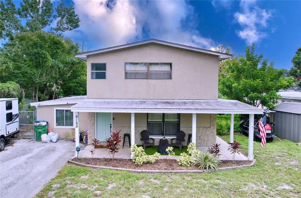 view of front of house featuring a front lawn and covered porch