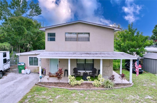 view of front of house featuring a front lawn and covered porch