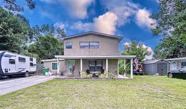 view of front of property featuring a storage unit and a front lawn