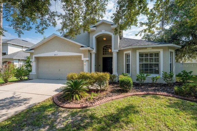 view of front of house with a front yard and a garage