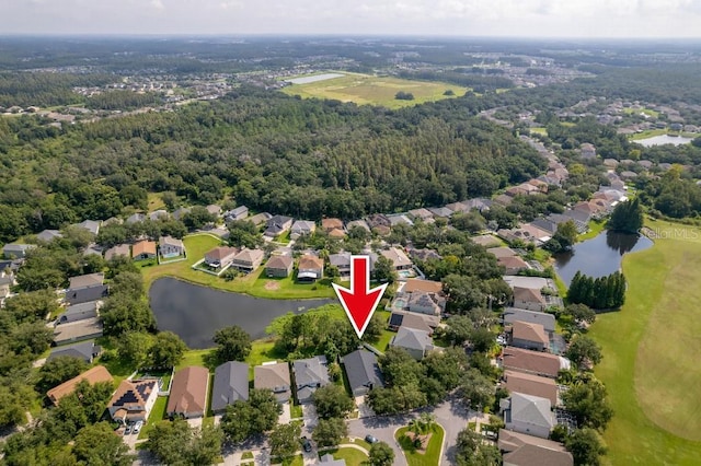 birds eye view of property featuring a water view, a residential view, and a view of trees