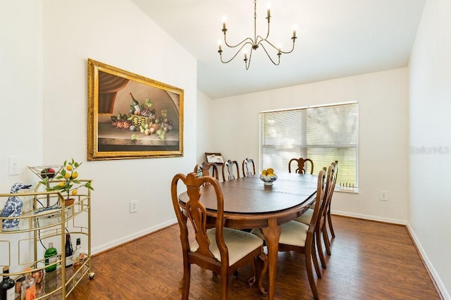 dining room with a notable chandelier, baseboards, and wood finished floors