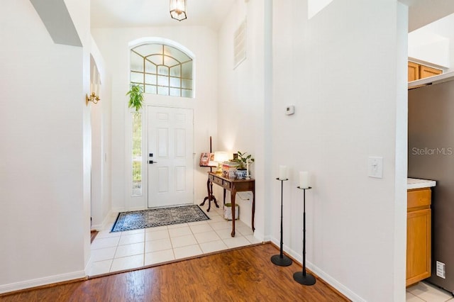 entrance foyer with light wood-style flooring and baseboards