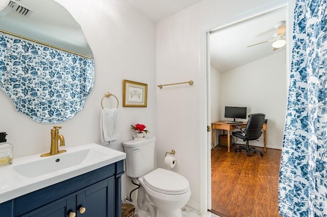 bathroom featuring visible vents, toilet, ceiling fan, vanity, and wood finished floors