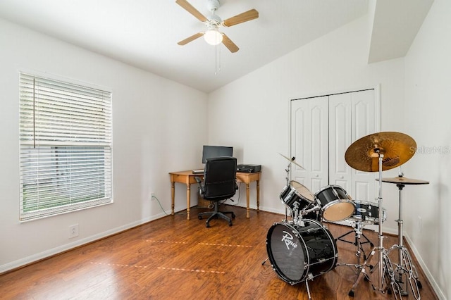 office featuring lofted ceiling, ceiling fan, baseboards, and wood finished floors