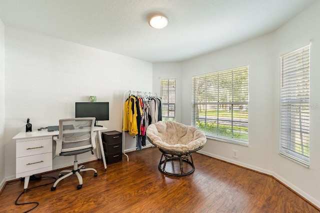 home office with dark wood-style floors and baseboards