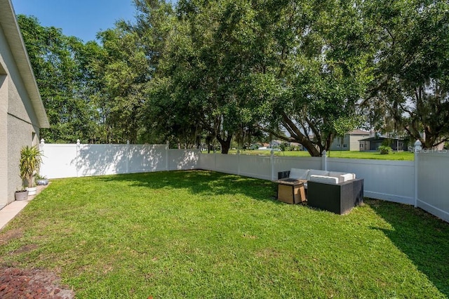 view of yard with outdoor lounge area and a fenced backyard