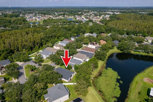 birds eye view of property featuring a water view, a wooded view, and a residential view