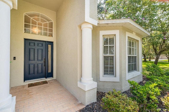 property entrance featuring stucco siding