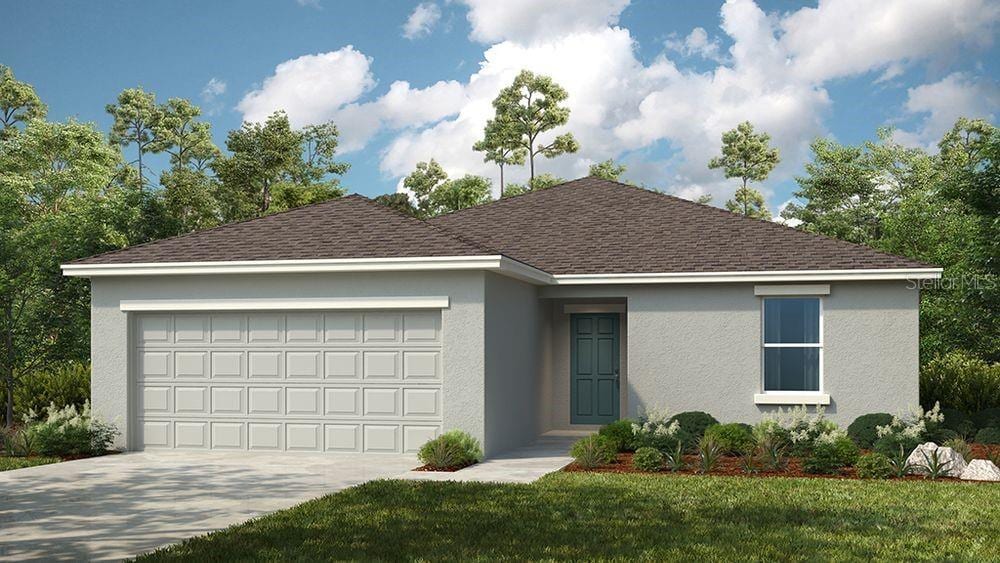 ranch-style home featuring a garage and a front yard