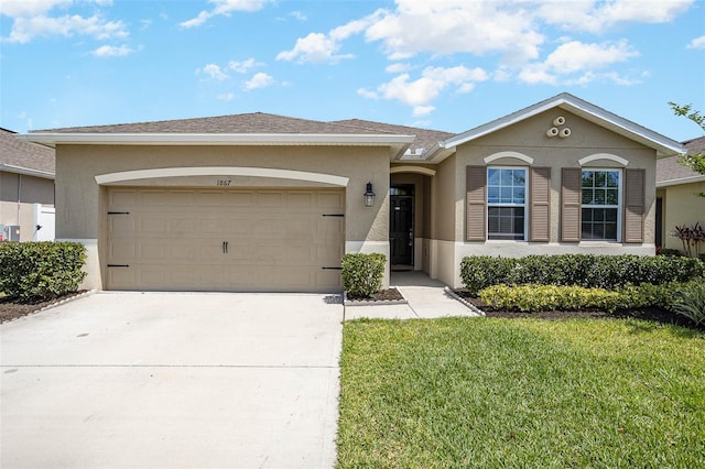 ranch-style home featuring a front lawn and a garage