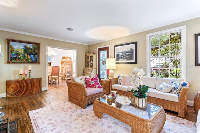 living room featuring hardwood / wood-style floors, a notable chandelier, and ornamental molding