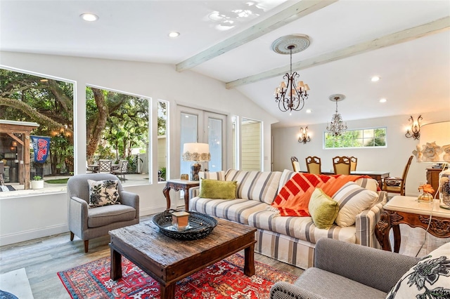 living room featuring a healthy amount of sunlight, an inviting chandelier, and lofted ceiling with beams