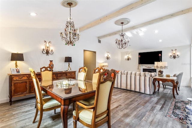 dining room with hardwood / wood-style floors, lofted ceiling with beams, and a chandelier