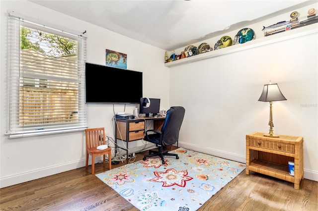 home office with wood-type flooring