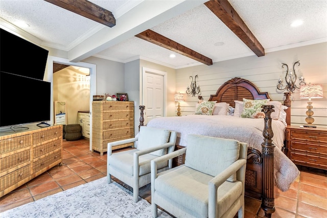 bedroom featuring a textured ceiling, beamed ceiling, and light tile patterned floors