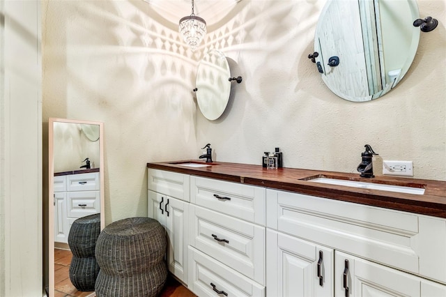 bathroom with tile patterned floors and double sink vanity