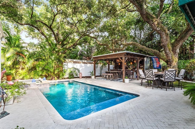 view of swimming pool featuring a patio area and a gazebo